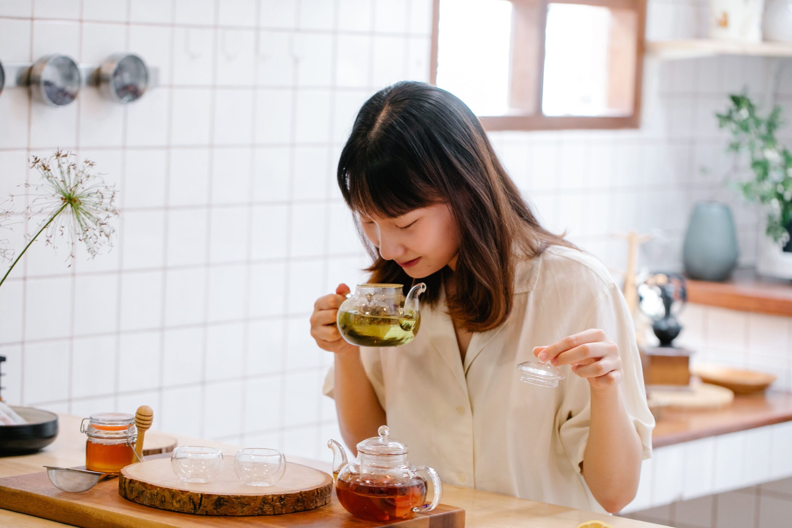 Woman drinking herbal tea to get rid of bloating fast at home